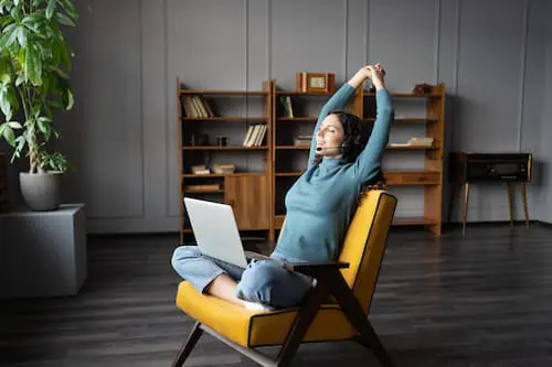 Woman working remotely to support their employee wellbeing