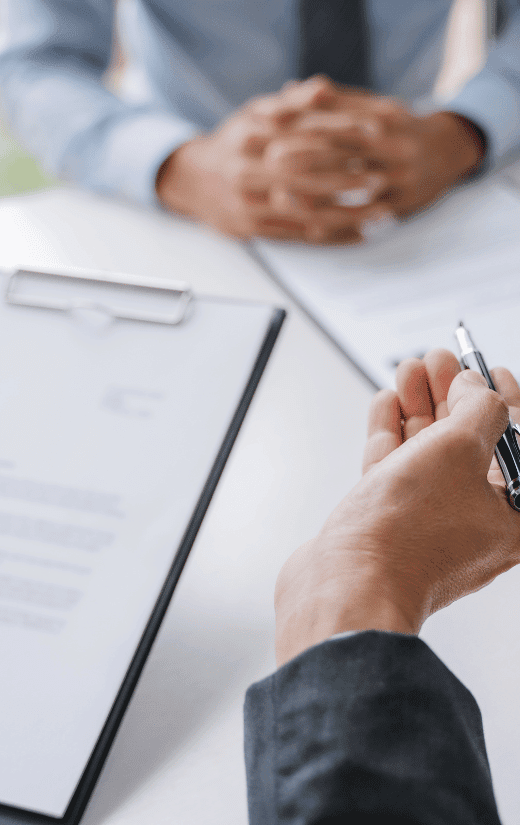 A group of finance professionals in a corporate meeting. A presentation highlighting the four most sought-after skills for finance careers in 2024. This image relates to a 2024 finance salary guide.