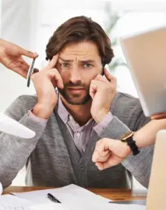 Overwhelmed recruiter struggling to fill open positions. Temporary workers: a solution to staffing shortages.